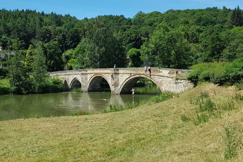 Jumping off the bridge to keep cool at Kirkham Abbey